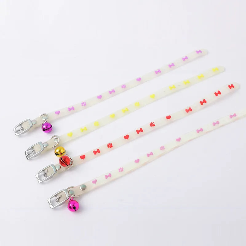 Luminous cat collar with glowing effect, silicone chain, metal bell, in a paw print pattern design.