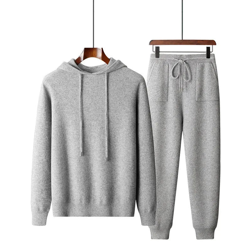 Men's light grey cashmere hooded sweatshirt and matching trousers set laid flat.