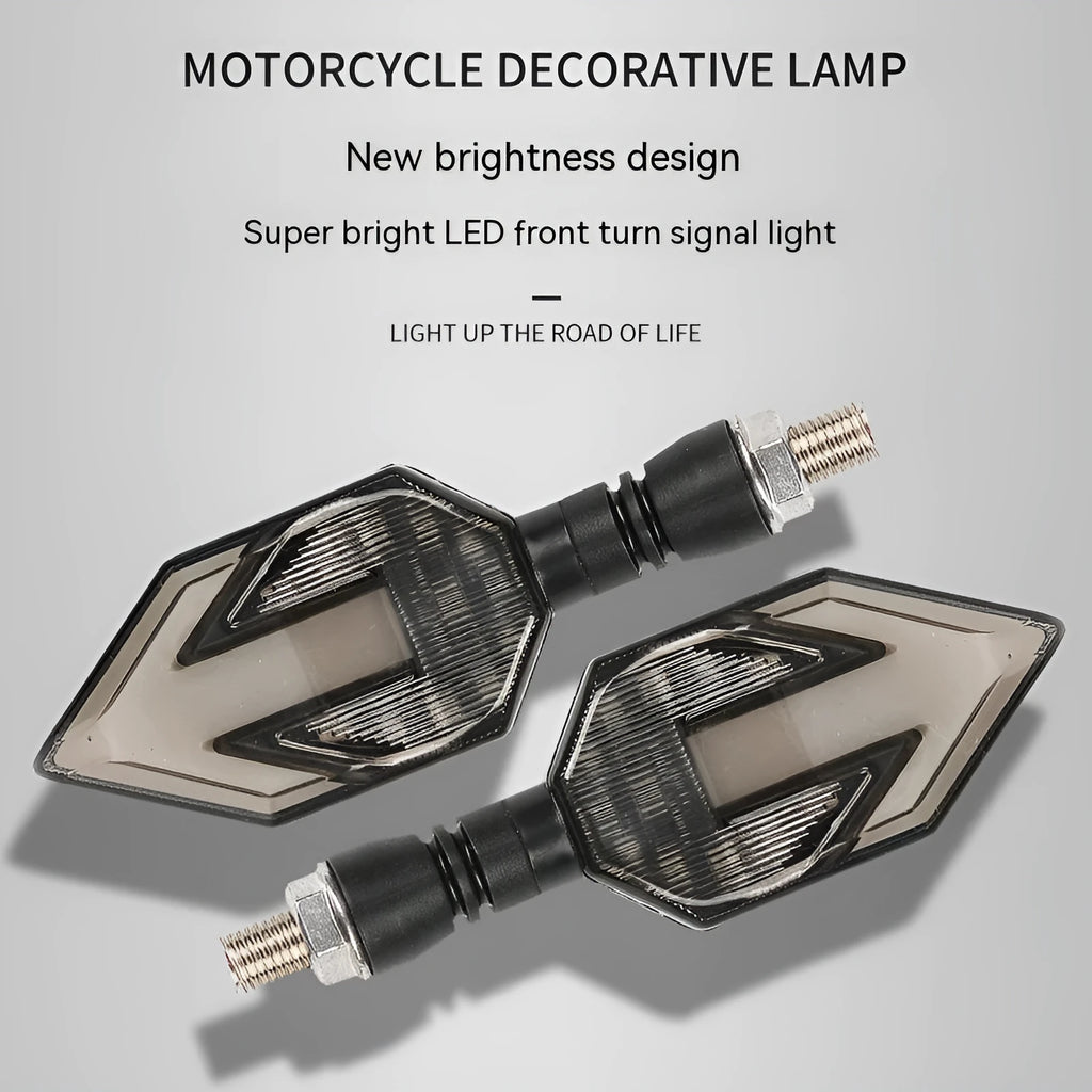 Arrow-shaped LED motorcycle turn signal light with 12V label and ABS plastic housing.