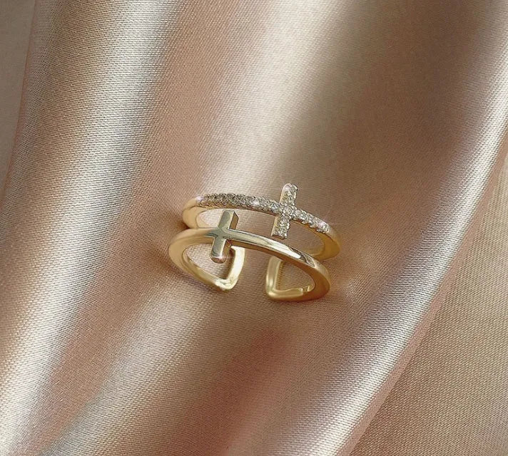 Double cross geometric women's ring with zircon stones on an adjustable copper band.