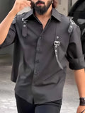 Men's black utility-style button-up shirt with a button-down collar on a hanger.