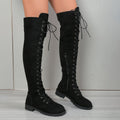 Black lace-up over-the-knee boots with decorative stitching, a round toe, and a flat rubber sole on a neutral background.
