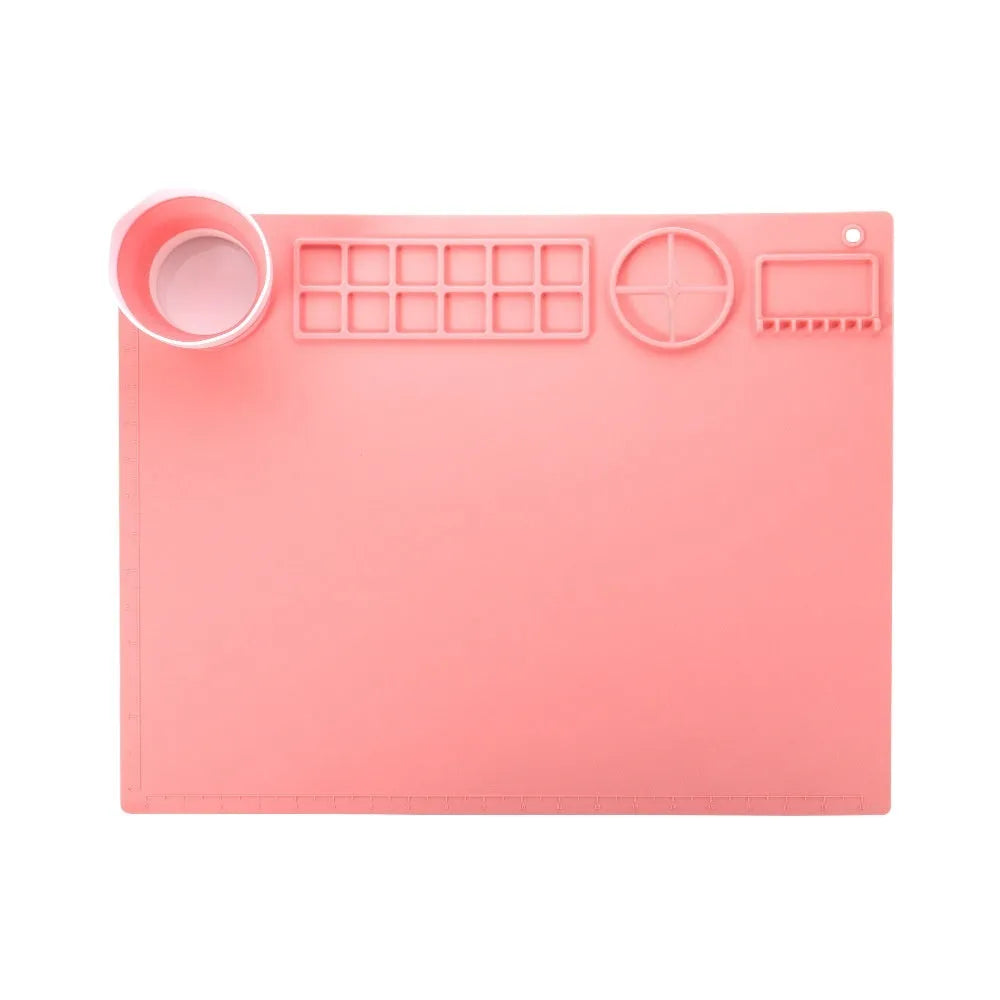 Large light blue silicone painting mat with dimensions 50cm by 40cm laid flat on a table.