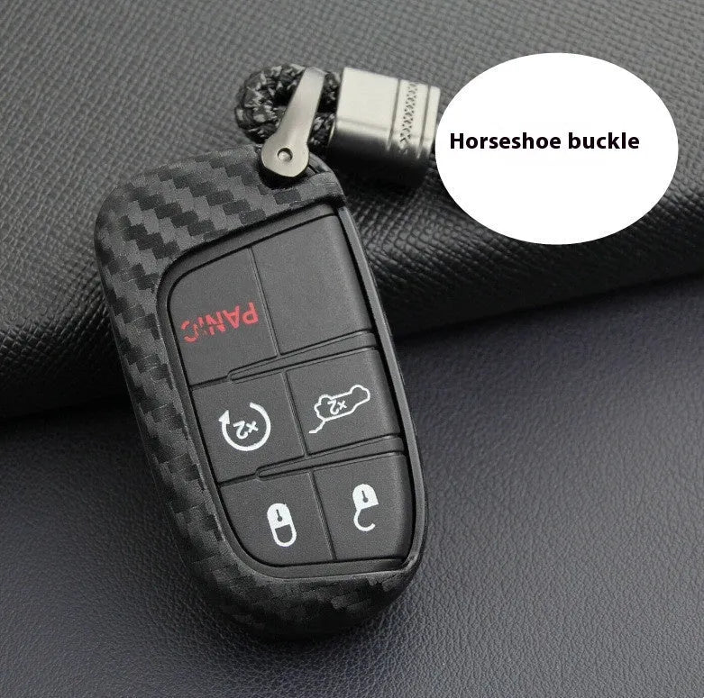 Black silicone protective case covering a Dodge car key fob, shown next to an unbuckled version.