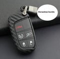 Black silicone protective case covering a Dodge car key fob, shown next to an unbuckled version.