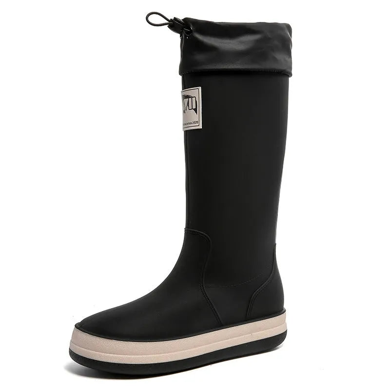 Solid colour high tube PVC rain boot in beige, shown on a white background.