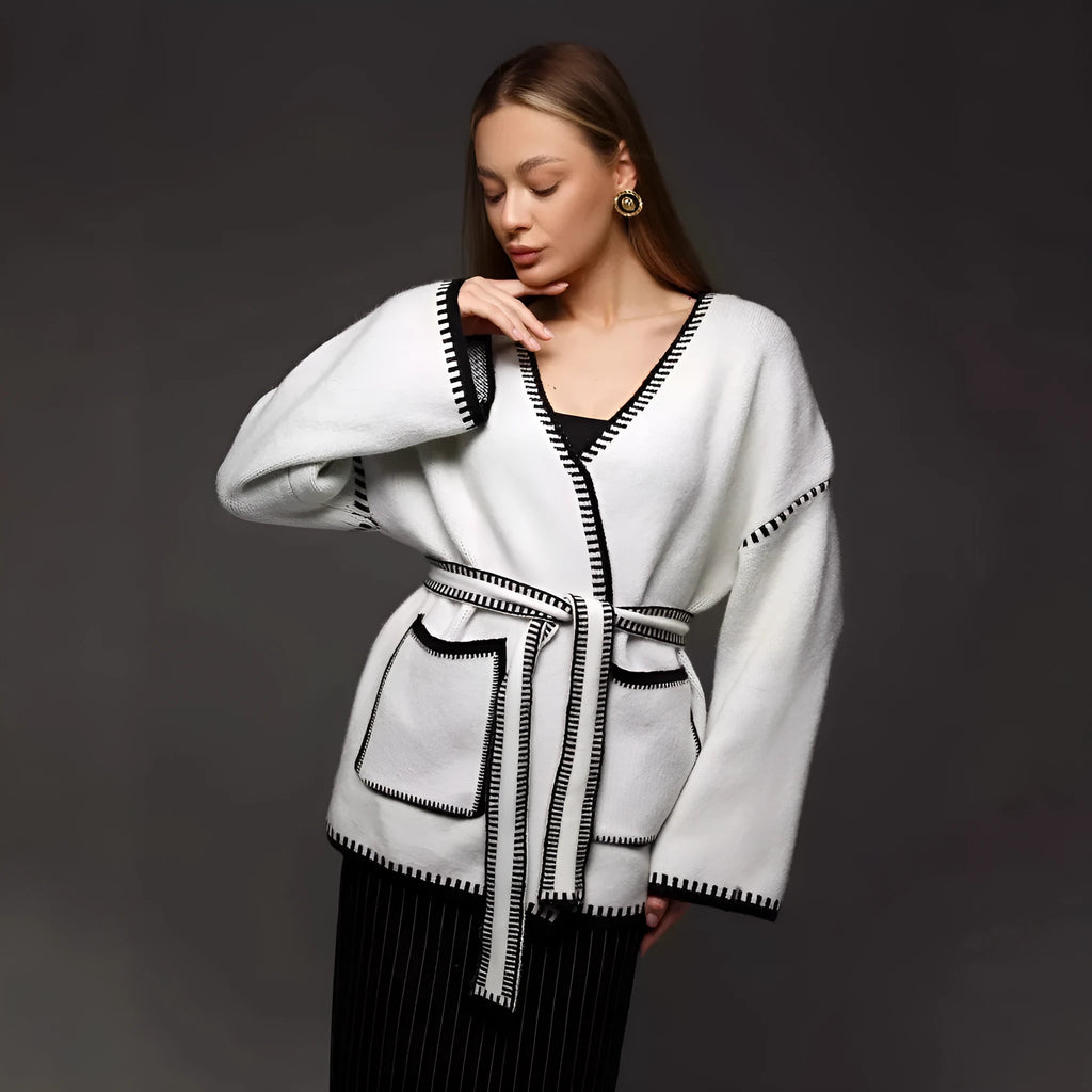 Loose fit lace-up knitted cardigan in black, shown as a mid-length sweater coat.