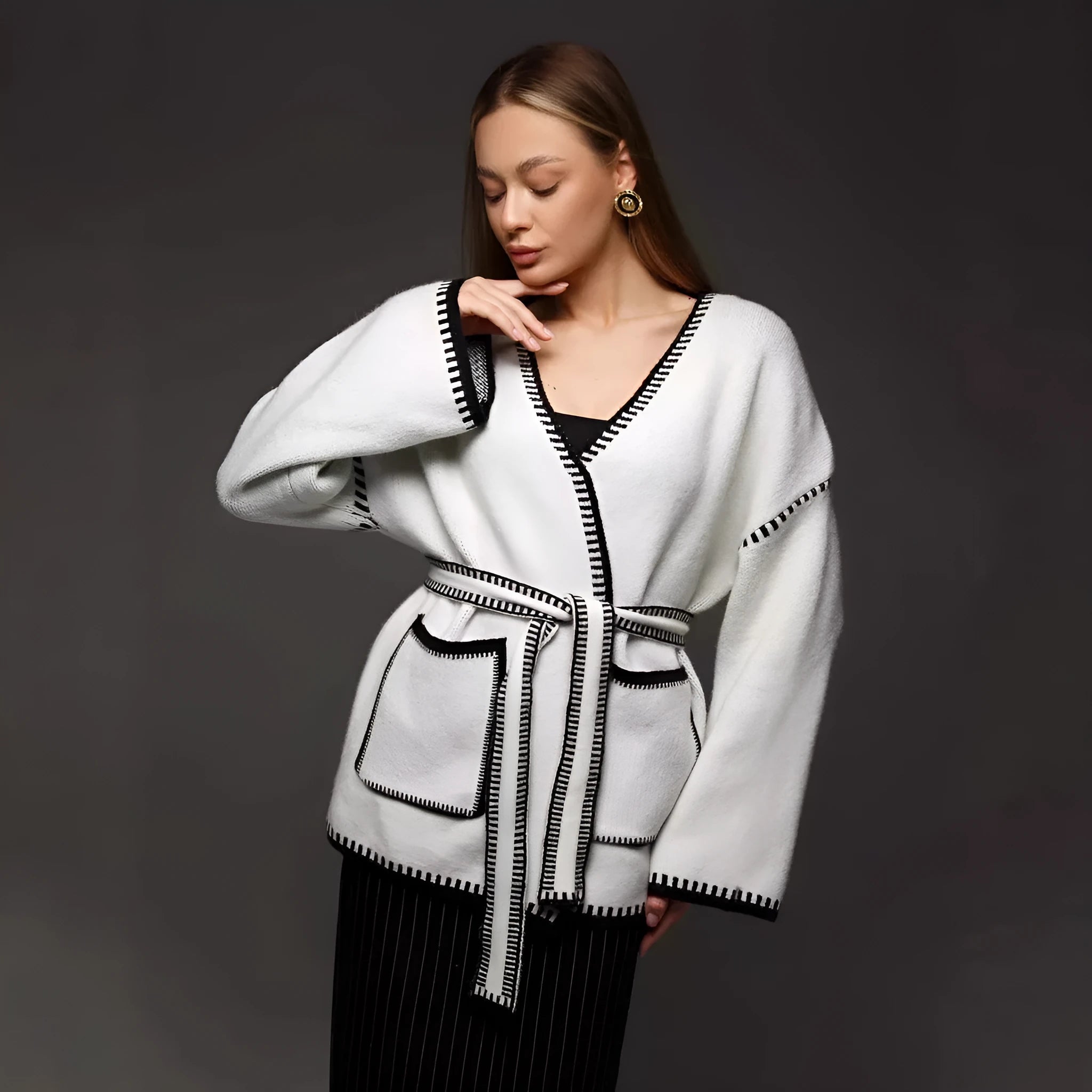 Loose fit lace-up knitted cardigan in black, shown as a mid-length sweater coat.