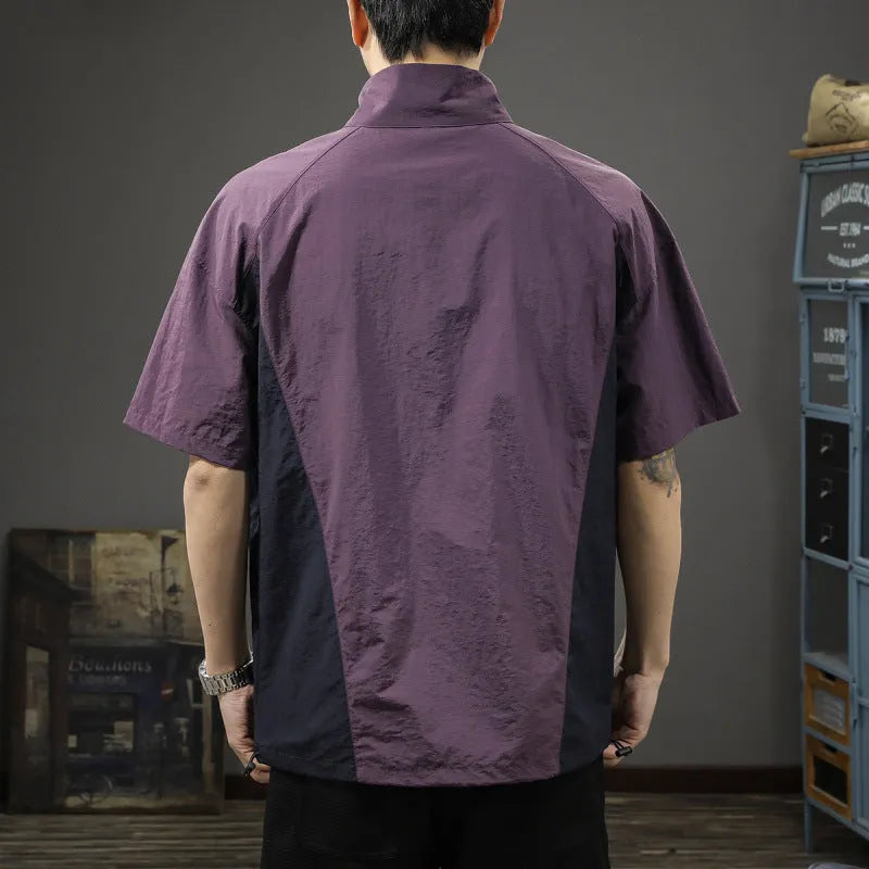 Brown men's half-zip stand collar short sleeve shirt with a fleece-lined interior on a hanger.