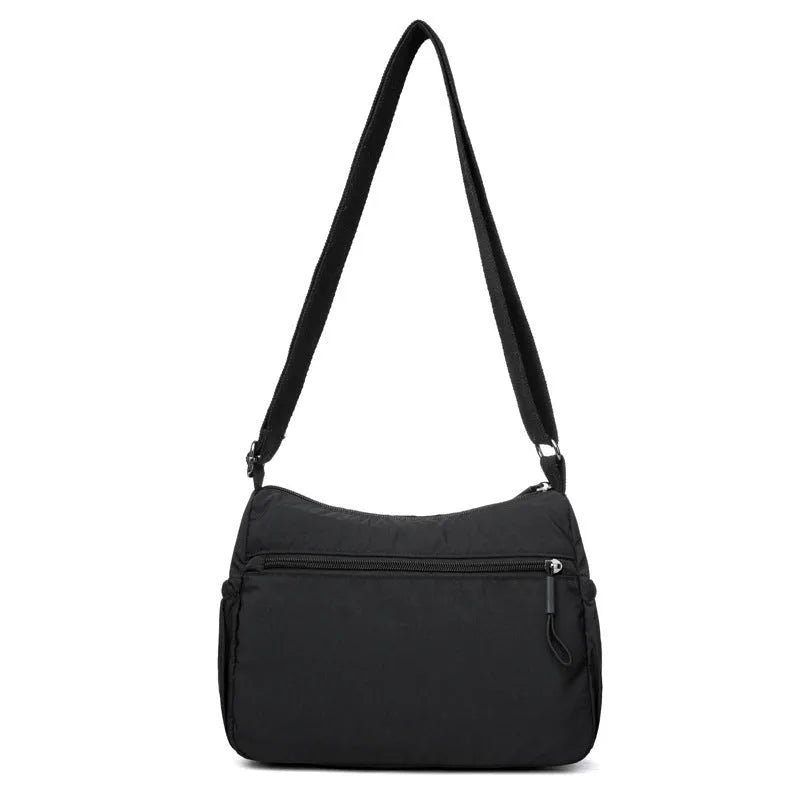 Water-repellent nylon crossbody bag with three-dimensional pocket shown in grey colour