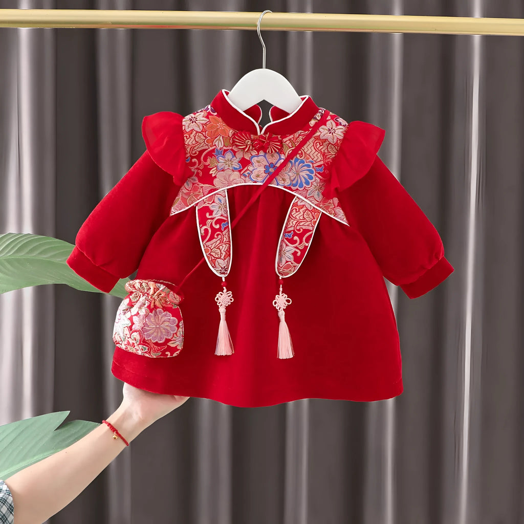 Girls winter velvet padded dress in retro red solid colour with long sleeves, front view on child