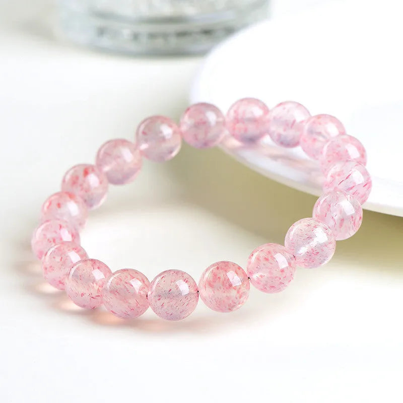 Strawberry quartz crystal bracelet with 10-10.8mm white water geometry beads on wrist
