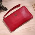 Long black PU leather zip wallet handbag open, showing phone slot and card organisers inside.