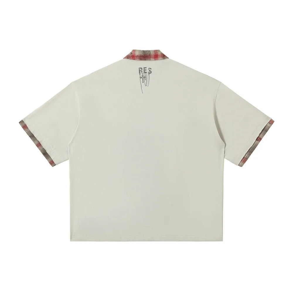 Men's loose blue short-sleeved top with a graffiti-style print on the lapel and an asymmetric hem.