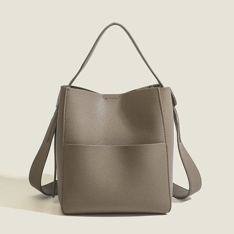 Bucket-style PU messenger bag with sewing line detail, available in black, brown, and elephant gray, on a plain background