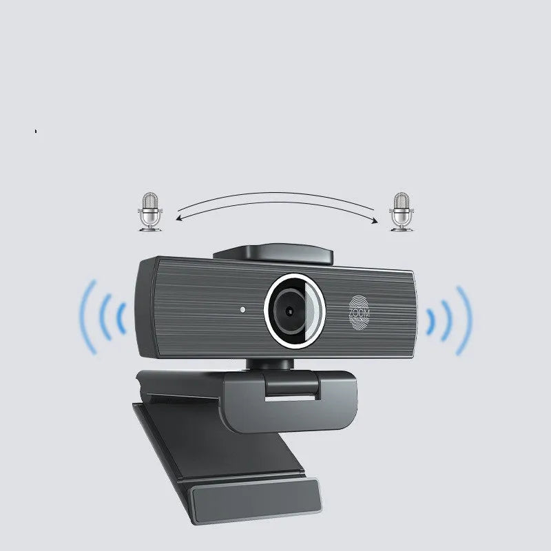 Black 4K USB webcam with attached cable and a magnetic privacy cover on a desk.