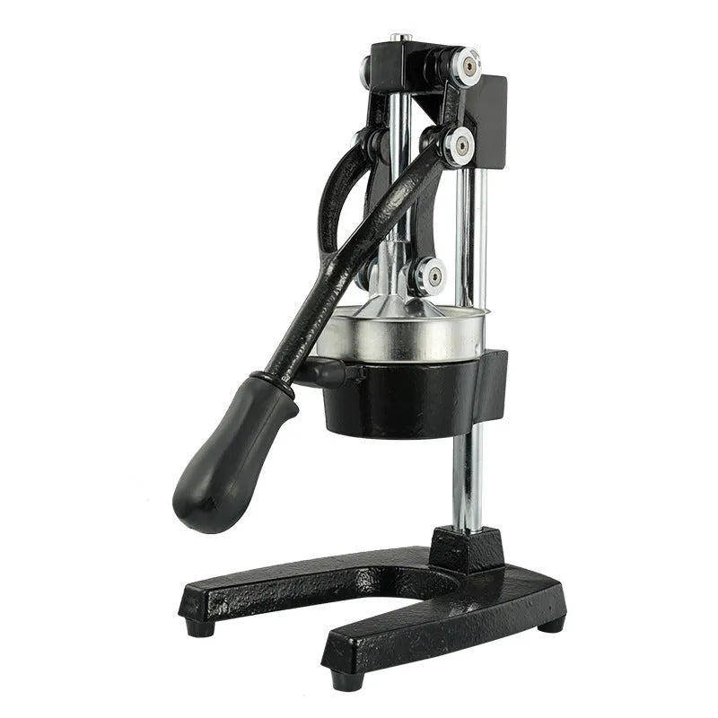Black cast iron manual citrus juicer with stainless steel funnel on a kitchen counter.