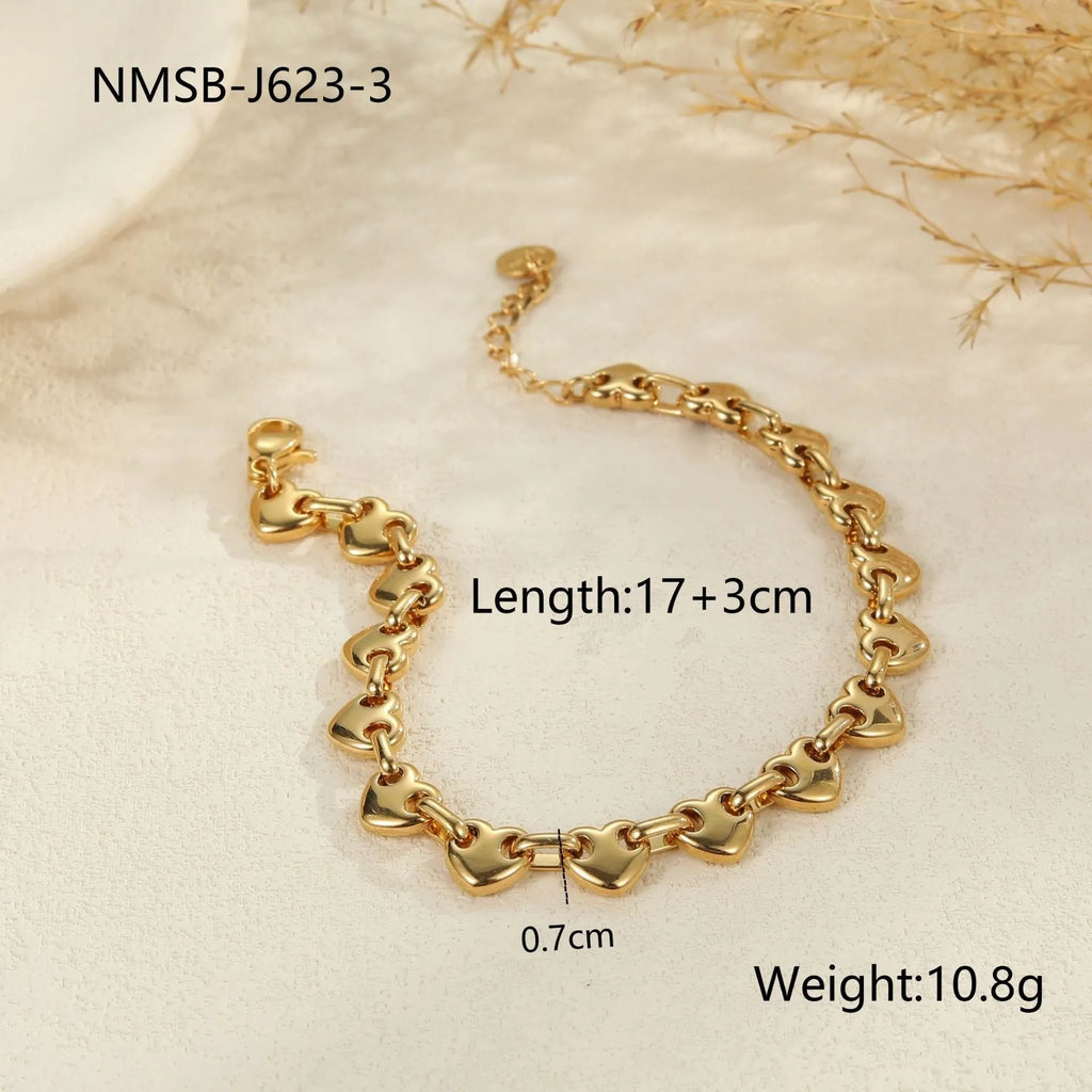 Women's stainless steel bracelet with a hollow geometric heart charm in gold, steel, or colour block finish.
