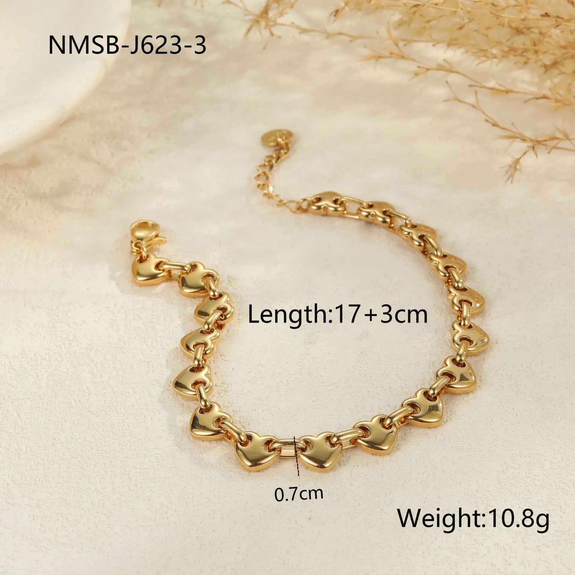Women's stainless steel bracelet with a hollow geometric heart charm in gold, steel, or colour block finish.