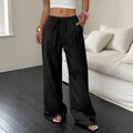 Women's black wide-leg trousers with a front lace-up detail on the waistband, laid flat.