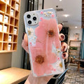 Pink and yellow floral patterned TPU back cover case for iPhone on a white background.