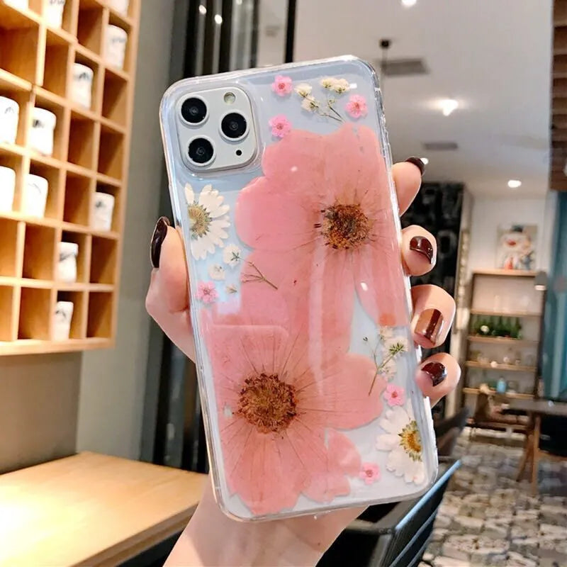 Pink and yellow floral patterned TPU back cover case for iPhone on a white background.