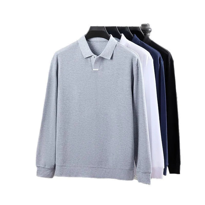 Man wearing a grey loose-fit cotton polo shirt with asymmetric lapels and long sleeves.