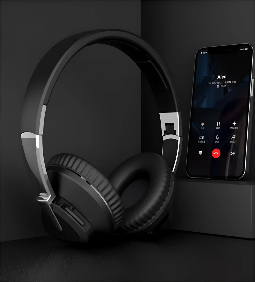 Black wireless over-ear Bluetooth headset with all-inclusive ear cups, showing AUX port and control buttons.