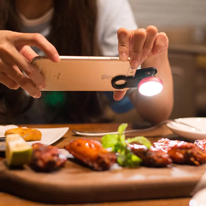 External wide-angle mobile phone camera lens with colourful LED lights in black, red, and silver grey