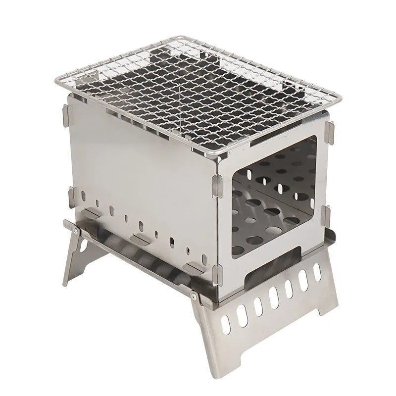 Silver outdoor folding card stove with grill mesh and storage bag on table