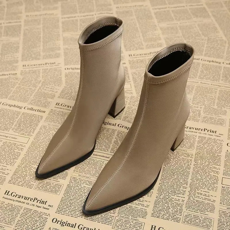 Women's khaki pointed toe fashion boots with a wedge heel on a neutral background.