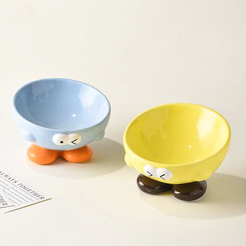 Cute Expression tall slanted ceramic pet food bowl in blue and yellow colours for cats and dogs