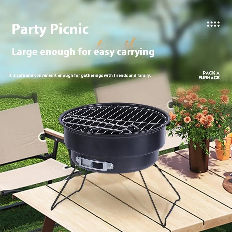 Small folding round metal ice stove with grill mesh and legs set up for outdoor barbecuing.