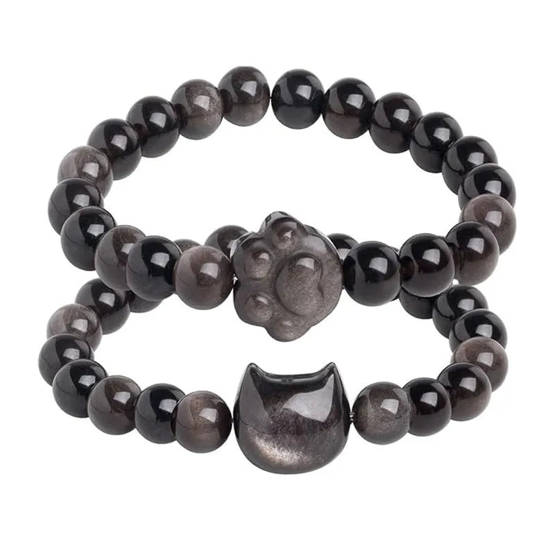 Handmade natural stone bead bracelet with silver cat pendant on neutral background