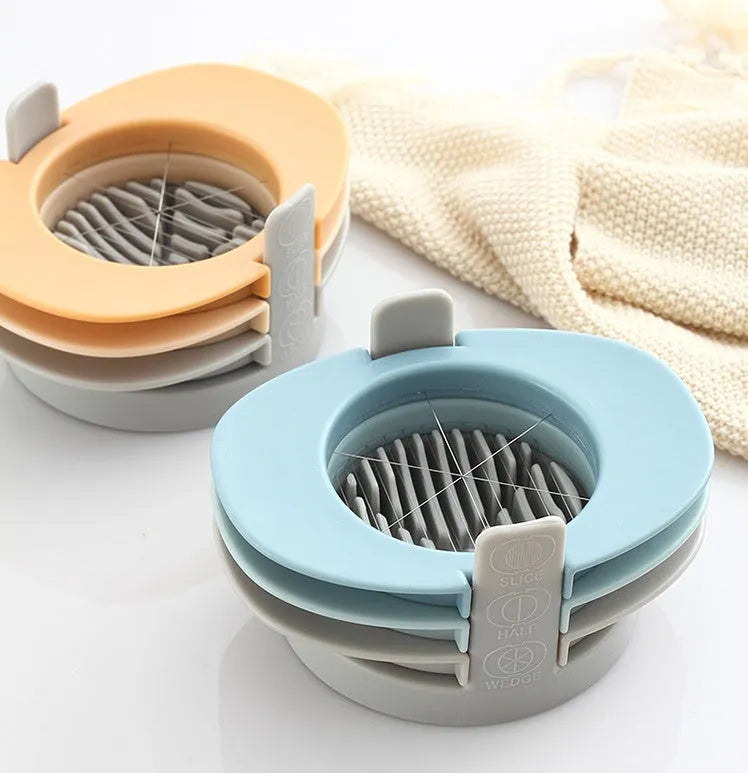 Manual three-in-one egg cutter in blue, orange and red with stainless steel blades and stackable design
