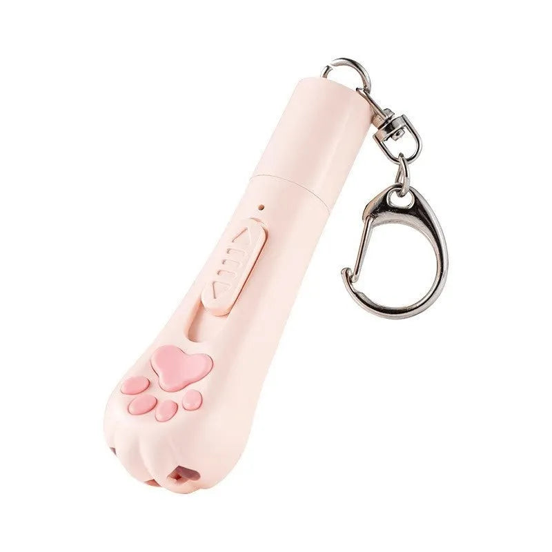 Pink USB-rechargeable cat toy base with a long white feather rotating on a wand, placed on a wooden floor.