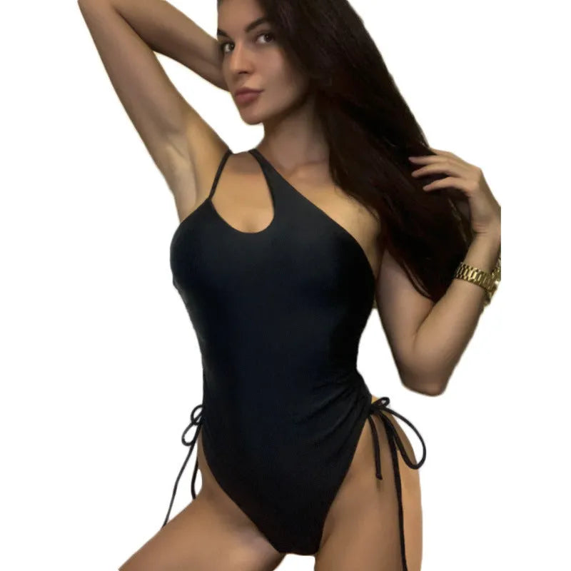 Black sleeveless women's dress with sloping shoulders and adjustable lacing detail
