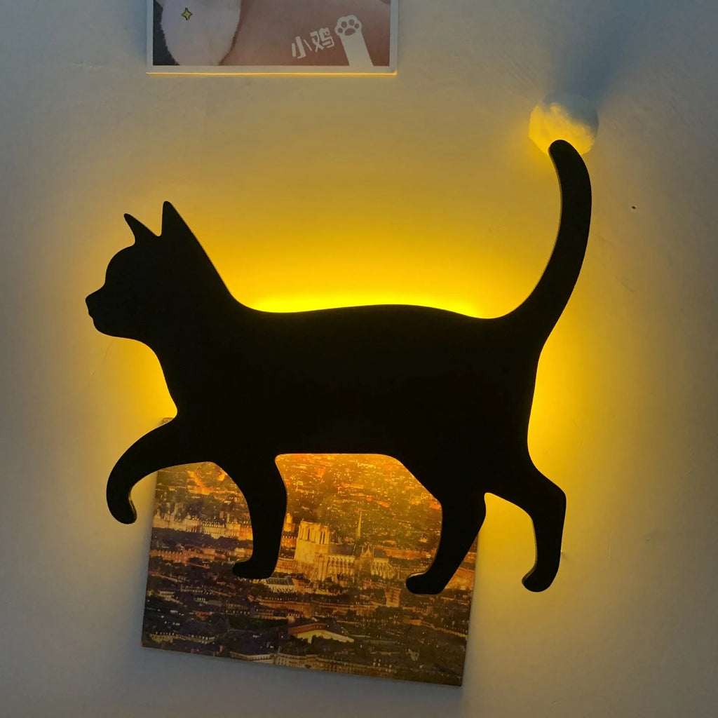 Black cartoon cat shaped LED night light with sound sensor for wall mounting.