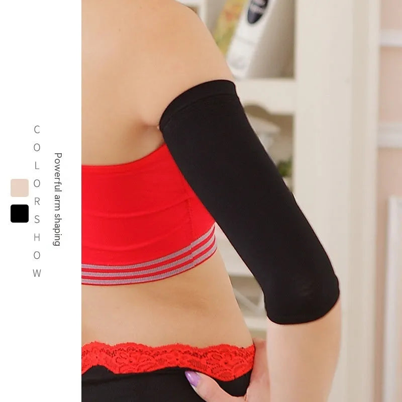 Pair of women's black shaping arm sleeves made from nylon fabric, laid flat.