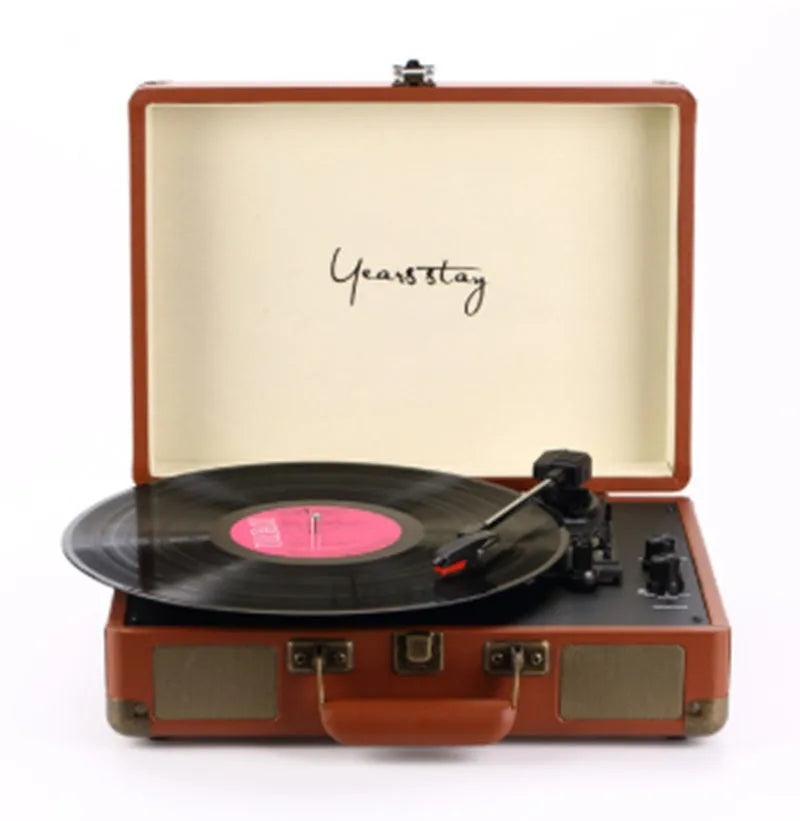 Portable Bluetooth phonograph turntable in a leather case, showing colour options.