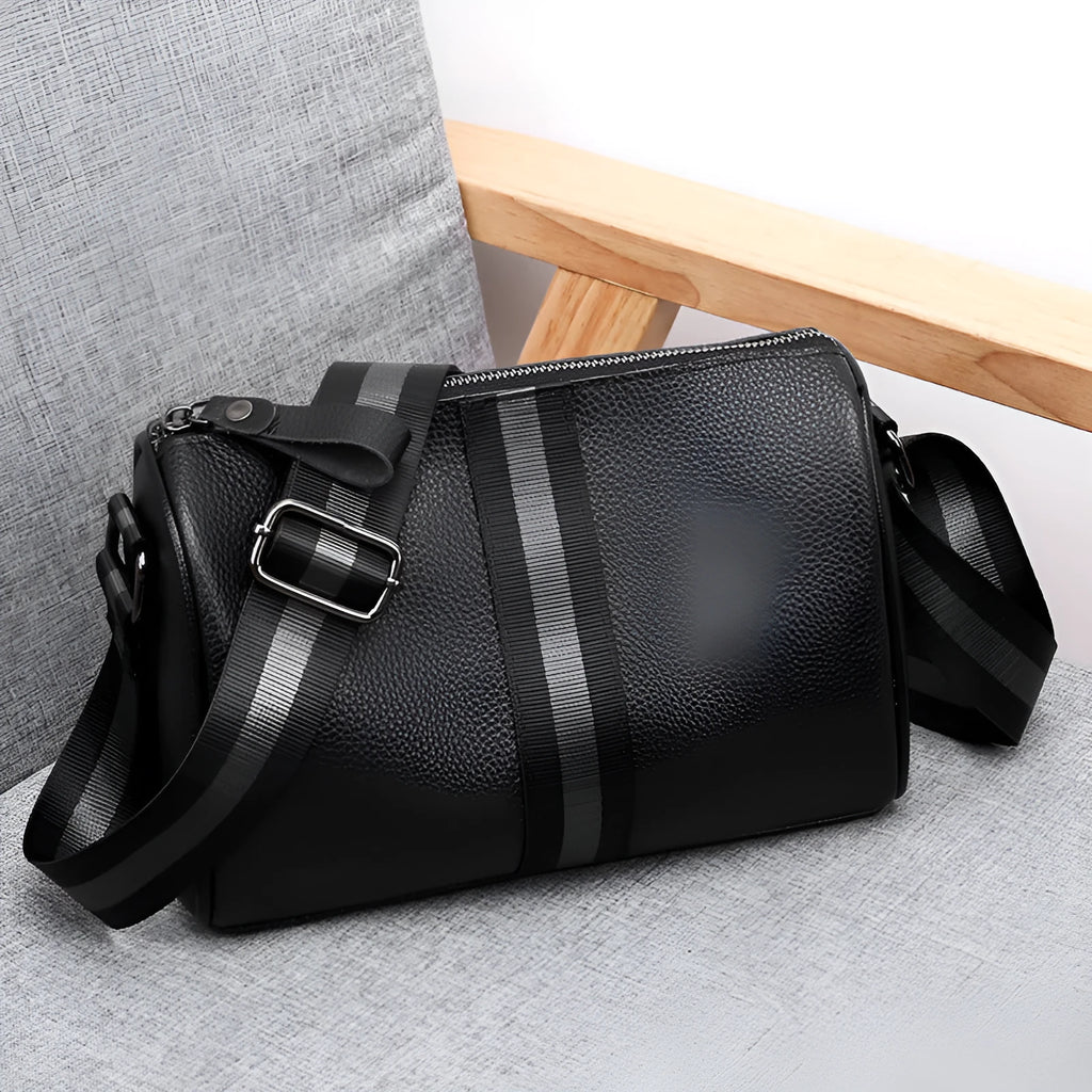 Black genuine leather one-shoulder crossbody bag showing dimensions and interior polyester lining