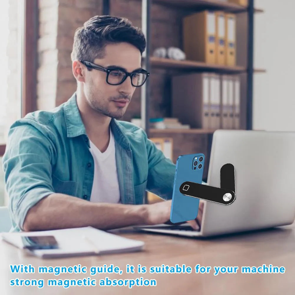 Black aluminium laptop phone holder with magnetic mount attached to side of silver laptop