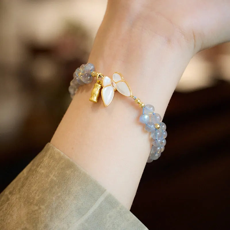 Grey moonstone woven bracelet with butterfly pattern and silver tone clasp