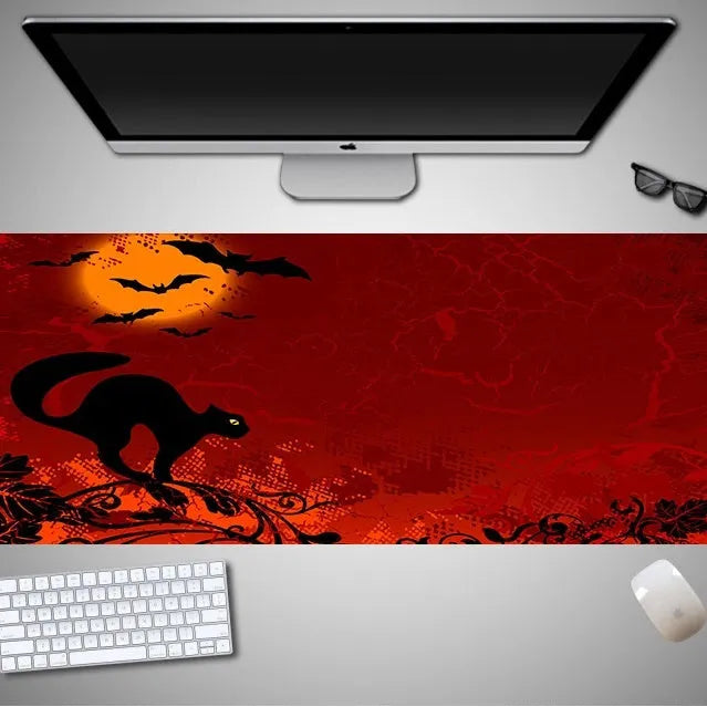 Large Halloween-themed rubber cloth mouse pad on a desk, showing non-slip backing and graphic design.