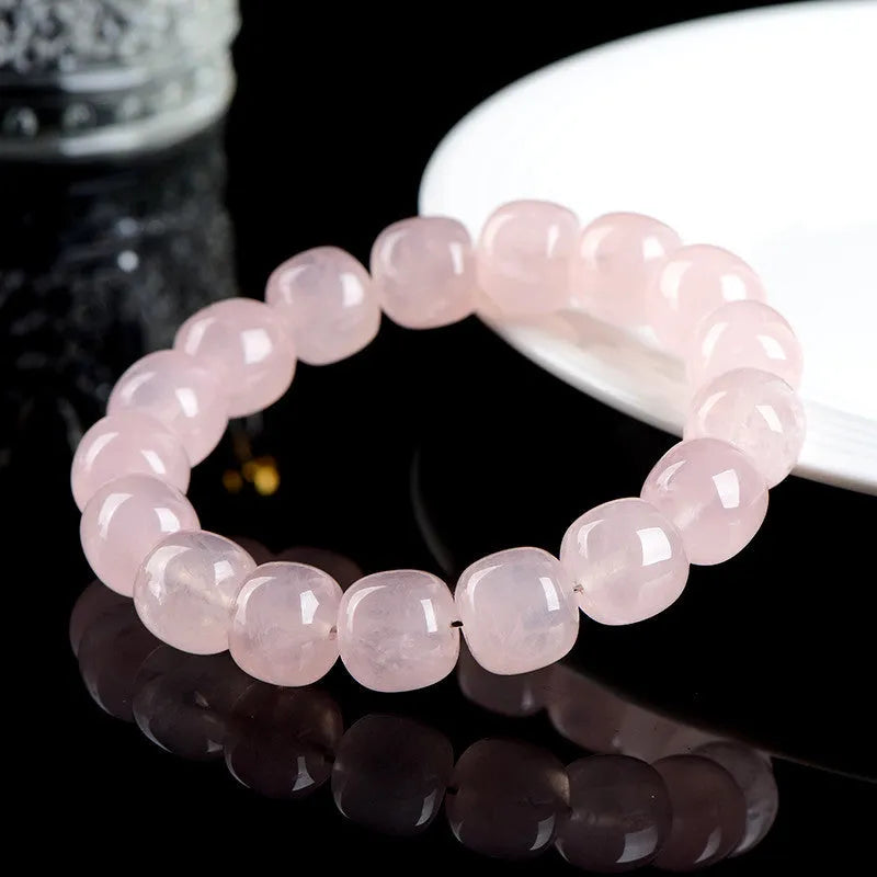Pink unisex crystal bracelet with geometric barrel beads measuring 11-12 mm.