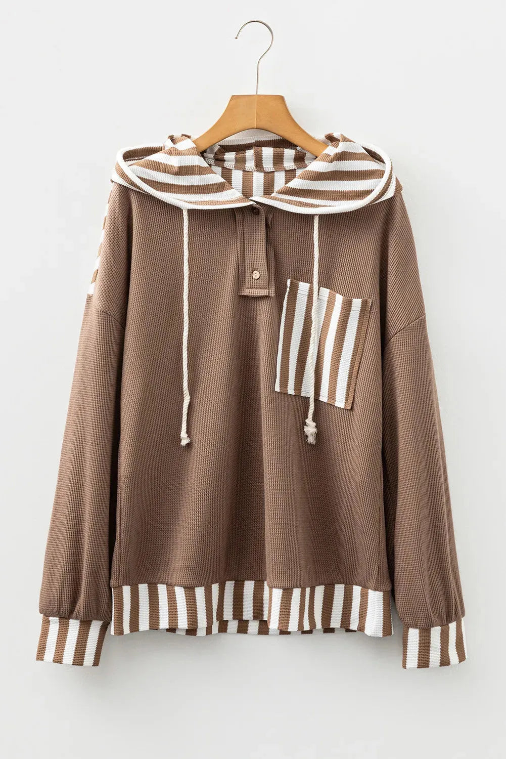 Straw yellow striped hoodie with waffle texture patchwork, button neck, and drawstring hood laid flat.