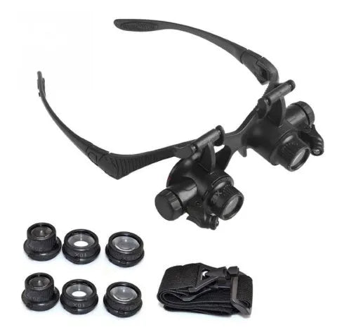 Black double eye magnifying glasses with LED lights and interchangeable lenses on a headband.