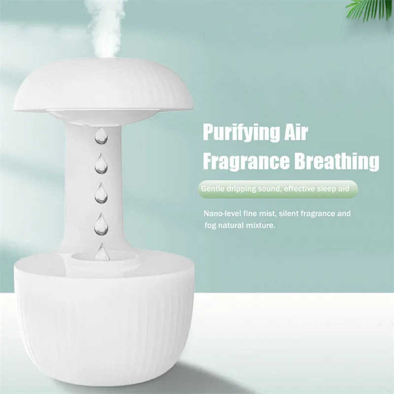 White anti-gravity humidifier showing water droplets levitating upwards from its mist outlet.