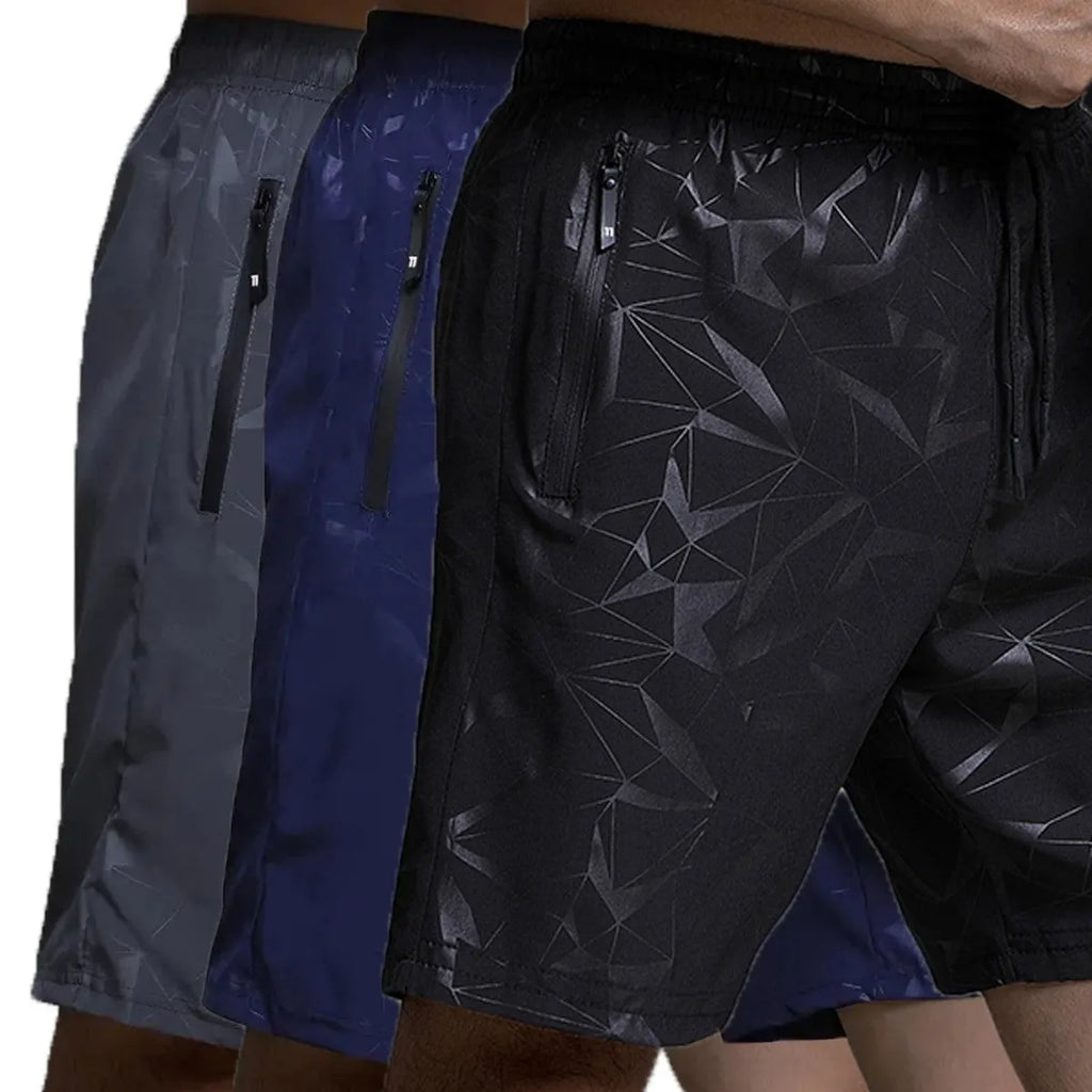 Man wearing loose black printed sports shorts on a beach.