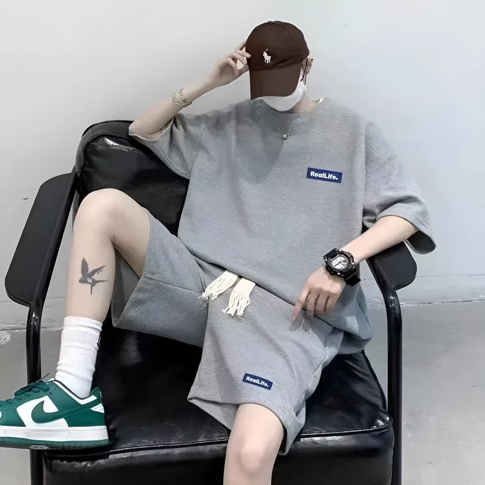 Men's waffle texture leisure set comprising a grey short-sleeve T-shirt and matching shorts on a hanger.